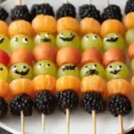 Spooky fruit kabobs decorated for Halloween with fruits and spooky elements