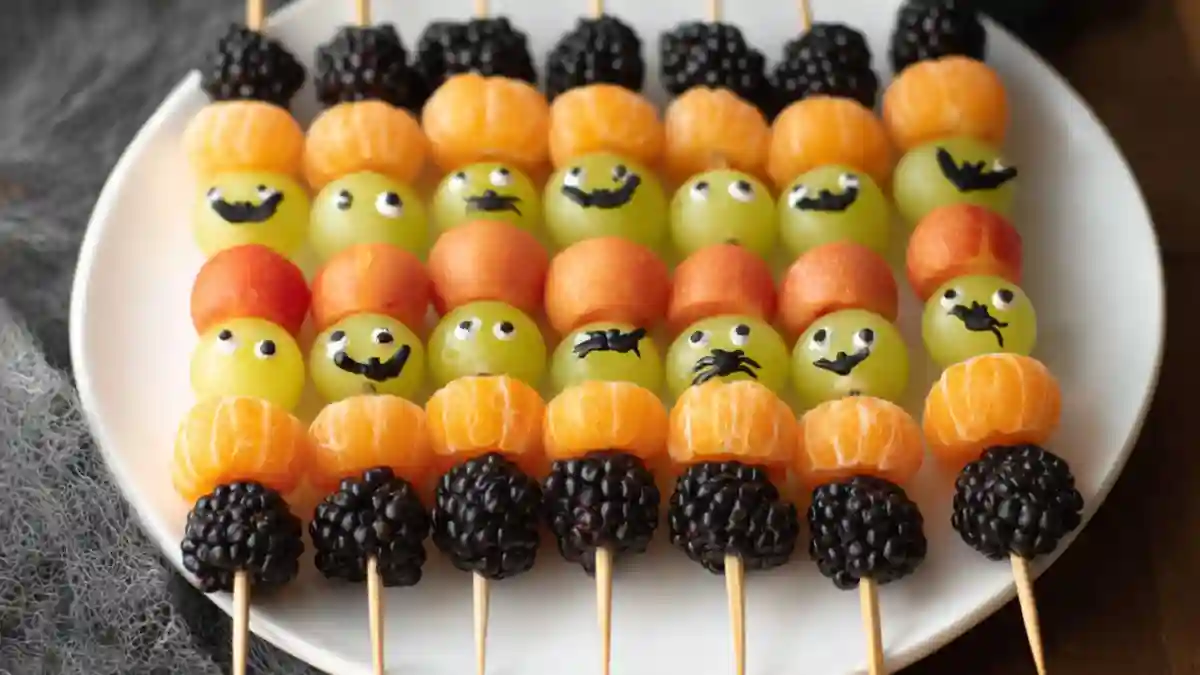 Spooky fruit kabobs decorated for Halloween with fruits and spooky elements