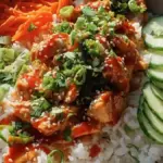 Bang Bang Chicken Bowl served with vibrant vegetables and spicy sauce