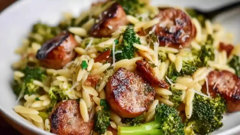 Chicken sausage and broccoli orzo dish served in a bowl