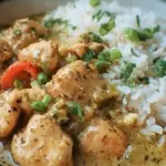 Delicious Coconut Chicken served with rice garnished with fresh herbs