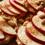 Crisp apple slices served with almond butter on a wooden table