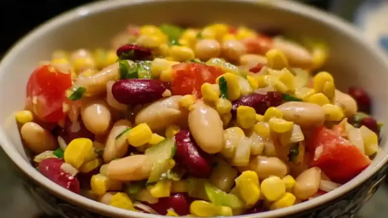 Fresh cold bean and corn salad served in a colorful bowl with vegetables
