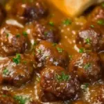 Bowl of Slow Cooker Salisbury Steak Meatballs served with gravy