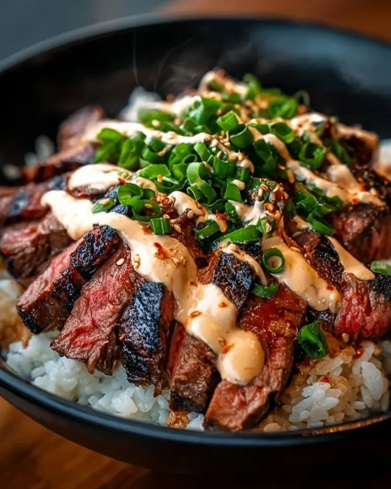 Delicious Korean BBQ steak rice bowl topped with vibrant vegetables.