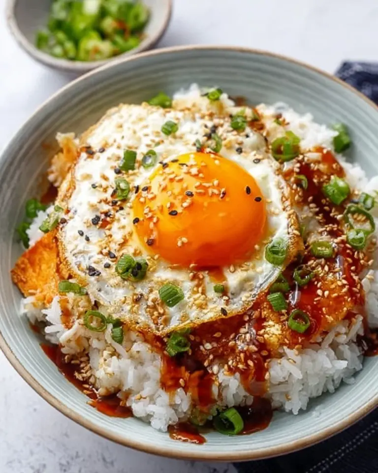 Bowl of Korean Egg Rice topped with a soft fried egg and green onions