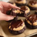 Brownie cookies with peanut butter frosting and chocolate ganache on a plate