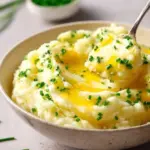 Buttery Instant Pot garlic mashed potatoes in a serving bowl