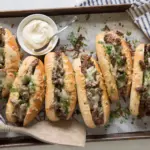Delicious cube steak sandwich with toppings on a rustic wooden table