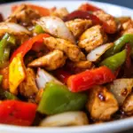 Delicious easy black bean sauce chicken served with vegetables and rice