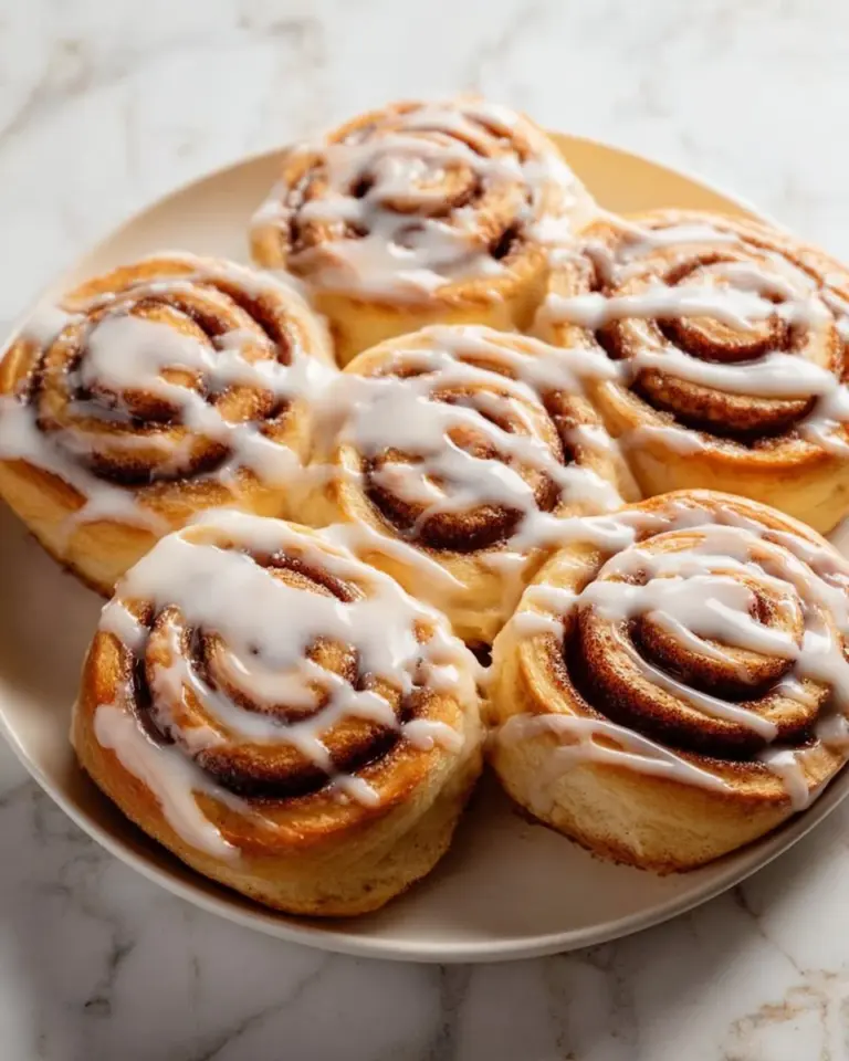 Delicious freshly baked eggnog cinnamon rolls topped with icing