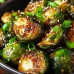 Honey Sriracha Brussels Sprouts drizzled with sauce and garnished