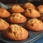 Freshly baked maple muffins with a golden brown top and maple glaze