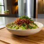 Crispy rice cucumber salad with lemon tahini dressing served in a bowl