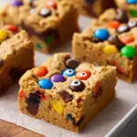 Delicious Sweet Halloween Monster Cookie Bars decorated with colorful candy