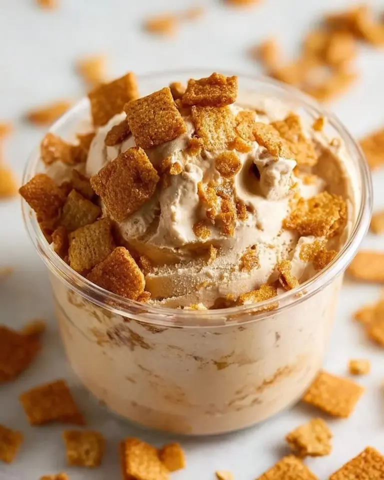 Bowl of cinnamon toast crunch protein ice cream topped with sprinkles and cinnamon.