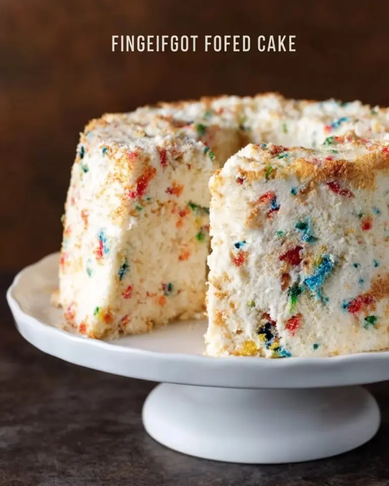 Slice of Funfetti Angel Food Cake topped with colorful sprinkles