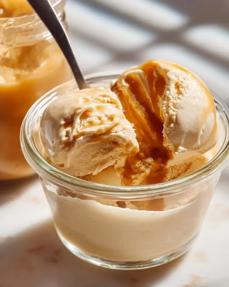 A bowl of healthy salted caramel ice cream topped with sea salt and caramel drizzle