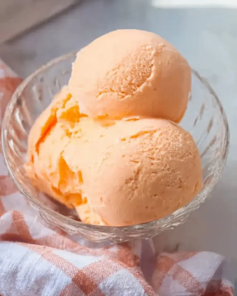Ninja Creami orange ice cream served in a bowl, showcasing its vibrant color and creamy texture.