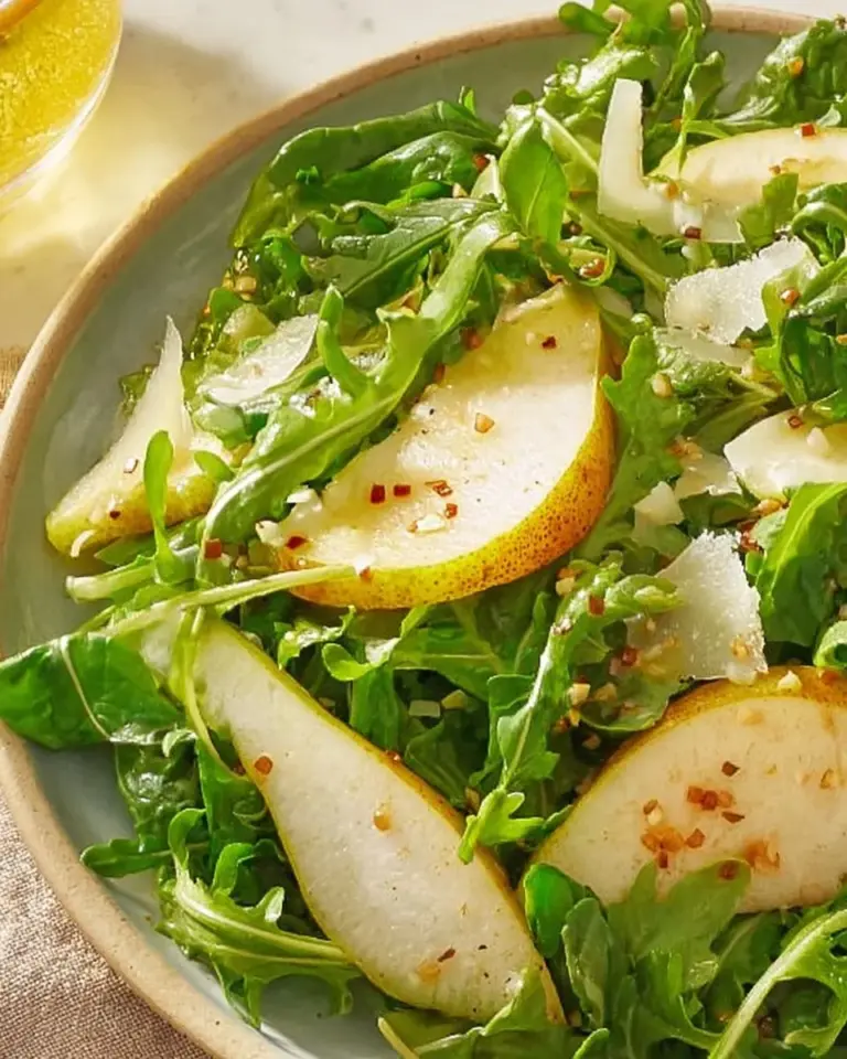 A vibrant Pear Rocket Salad featuring fresh greens and ripe pears.