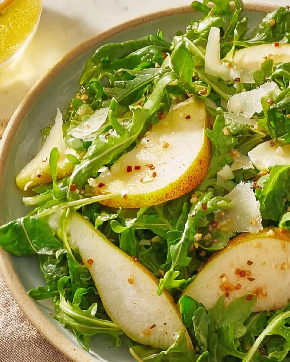 A vibrant Pear Rocket Salad featuring fresh greens and ripe pears.