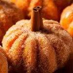 Freshly baked pumpkin donuts with spices and a dusting of sugar