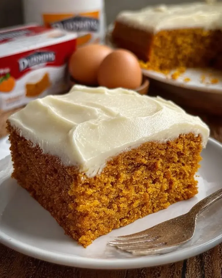 Delicious homemade Pumpkin Spice Cake topped with cream and spices
