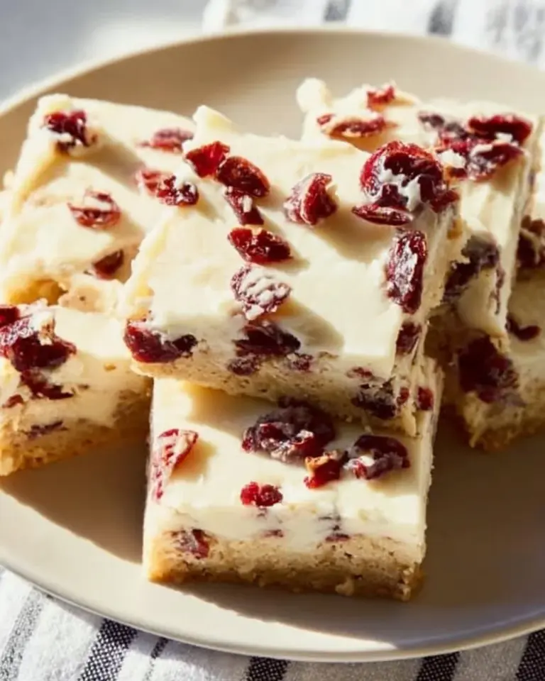 Delicious homemade cranberry bliss bars topped with cream cheese frosting