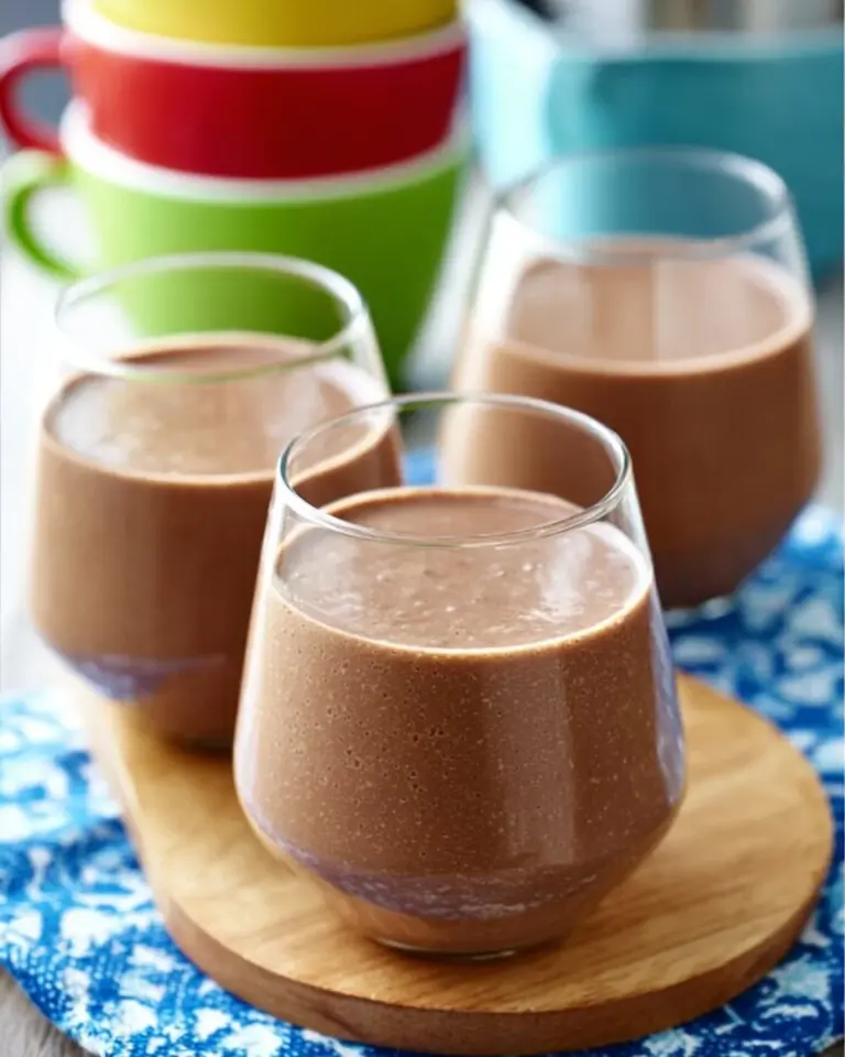 Creamy date coffee breakfast smoothie topped with dates and coffee beans