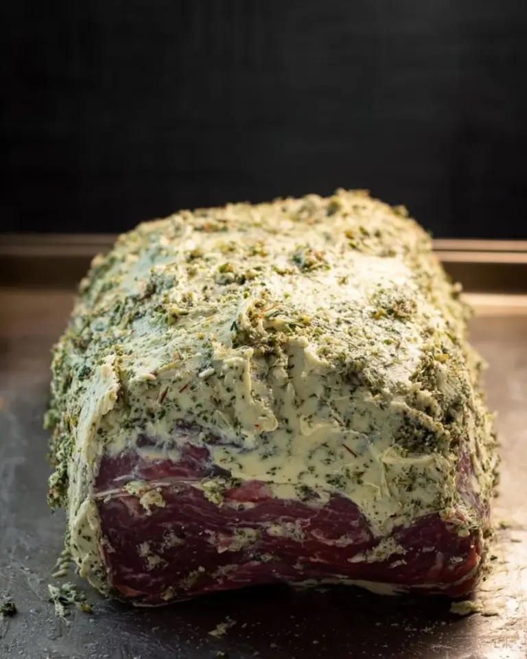 Garlic Butter Prime Rib Roast garnished with herbs and ready to serve