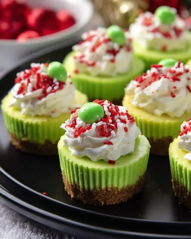 Festive Grinch mini cheesecakes decorated for the holiday season