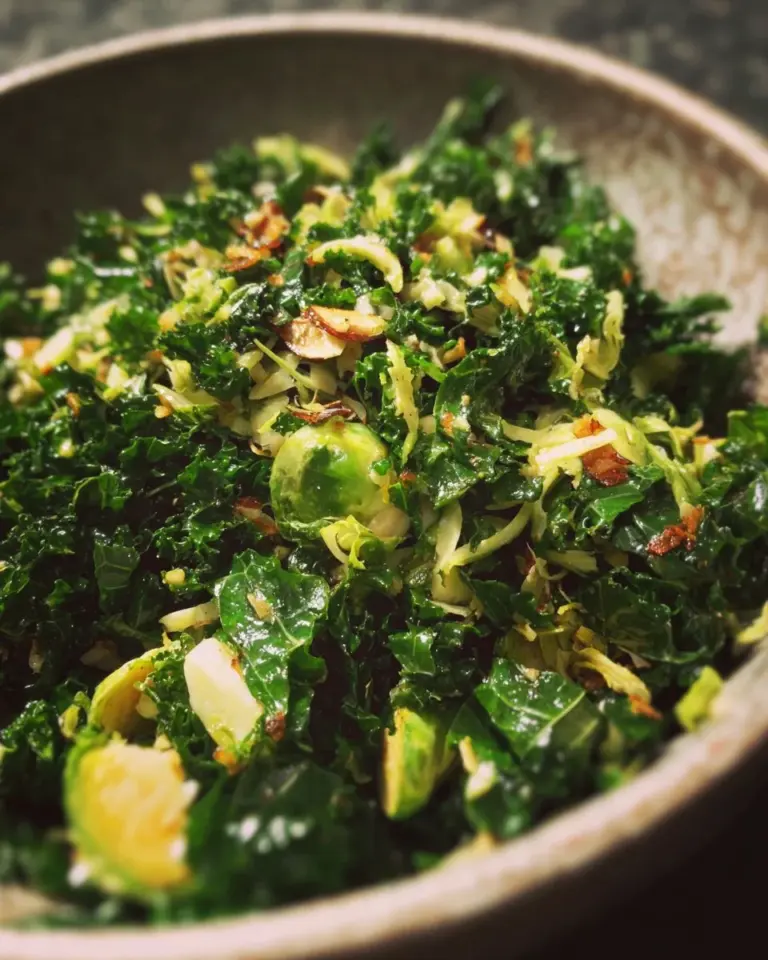 Shredded Kale and Brussels Sprout Salad with colorful vegetables and dressing