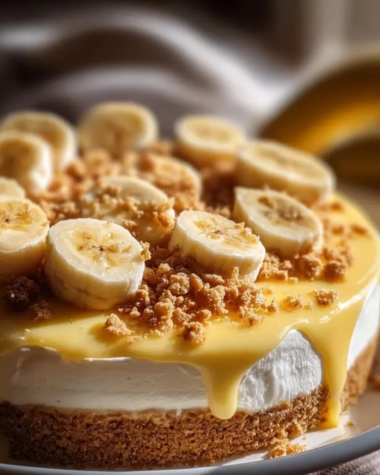 Banana Pudding Crunch Cheesecake topped with banana slices and crunchy layers
