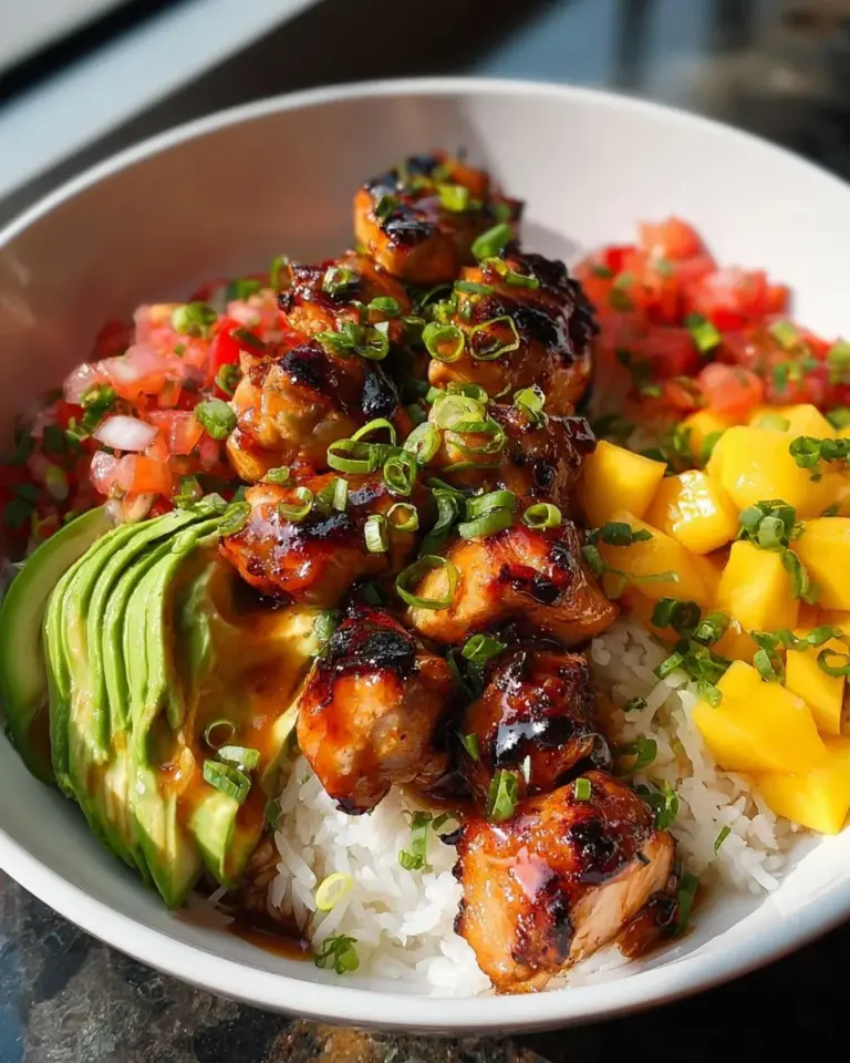 Grilled maple sriracha chicken bites served with coconut rice and mango avocado salsa