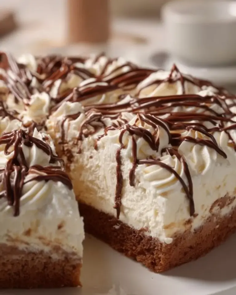 Nutella Three Milk Cake topped with chocolate and hazelnuts