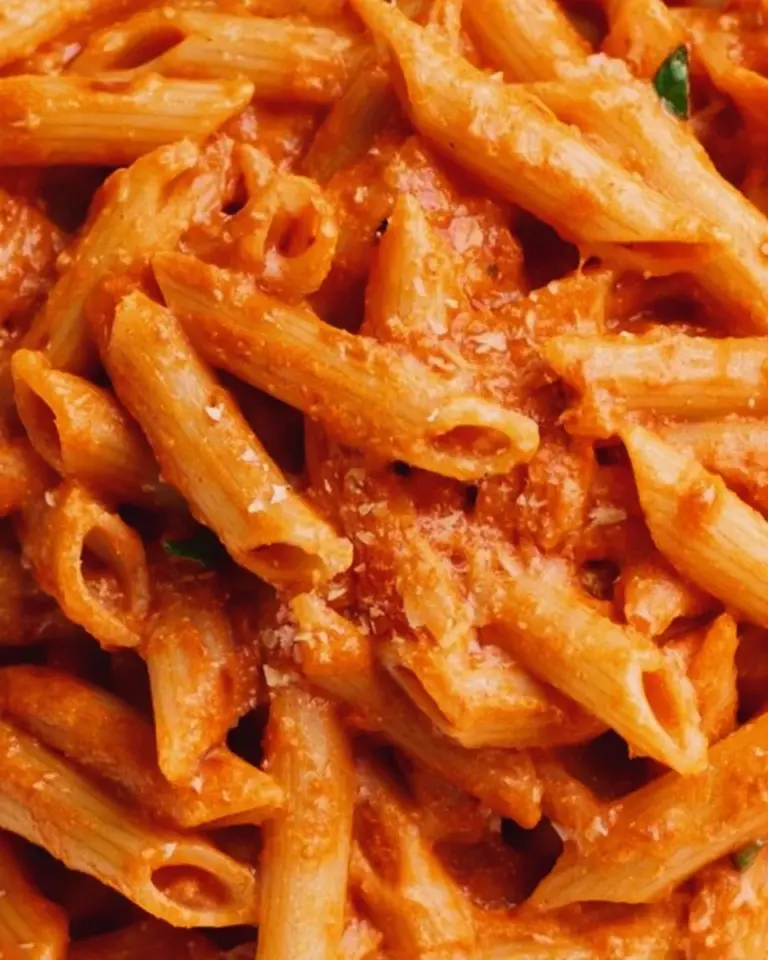 Penne pasta with creamy vodka sauce garnished with herbs