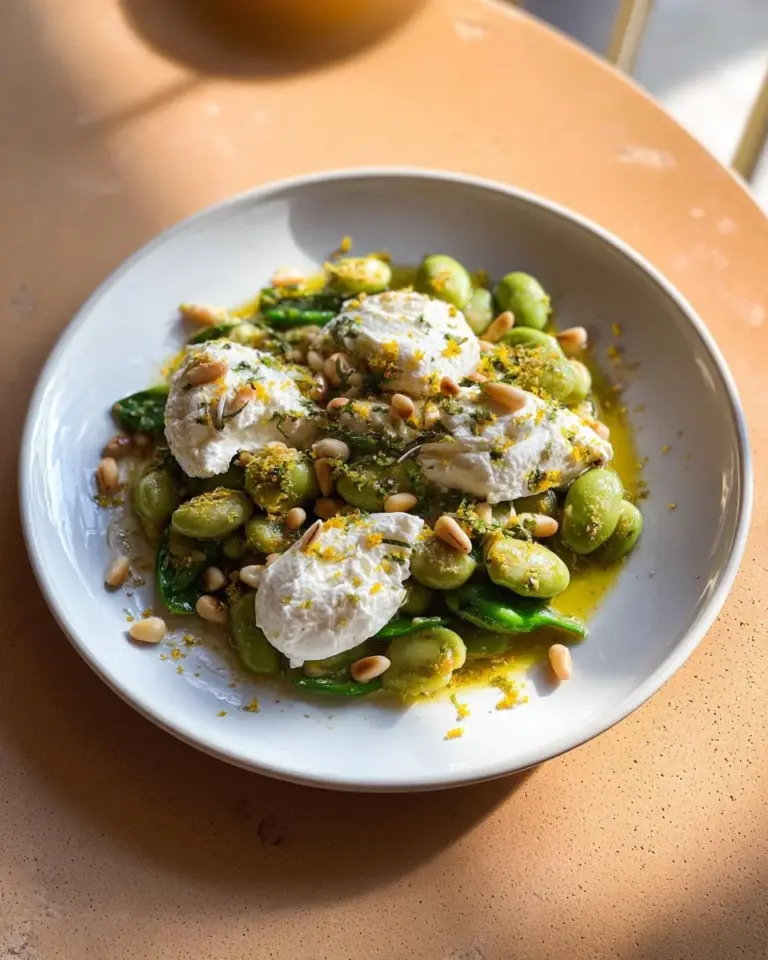 Pesto zucchini dish with ricotta and butter beans served in a bowl