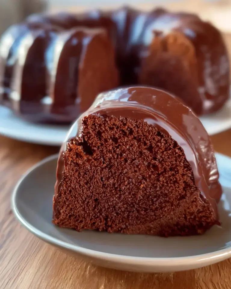 Easy Moist Chocolate Cake topped with chocolate frosting and sprinkles