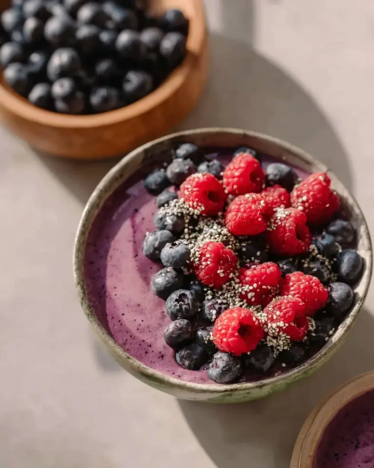 Colorful Ninja Creami smoothie bowl topped with fresh fruits and granola.