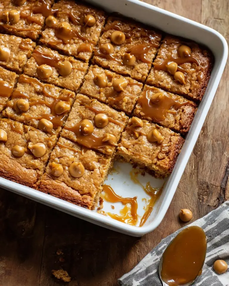 Delicious butterscotch oat bars on a wooden table with a sprinkle of oats