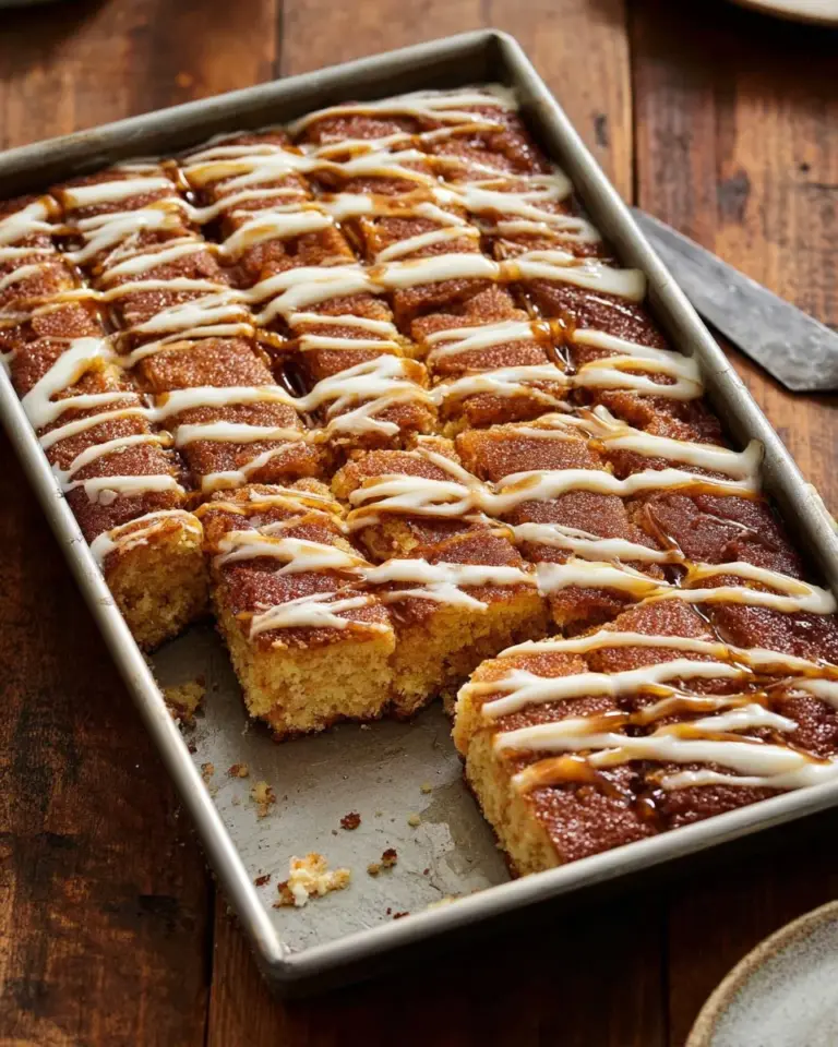 Cinnamon Sugar Focaccia drizzled with cream cheese frosting on a wooden board