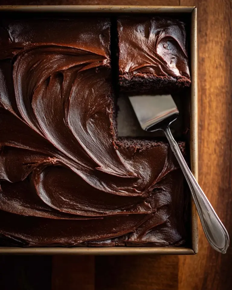 Rich and decadent Double Fudge Whiskey Cake topped with chocolate glaze.