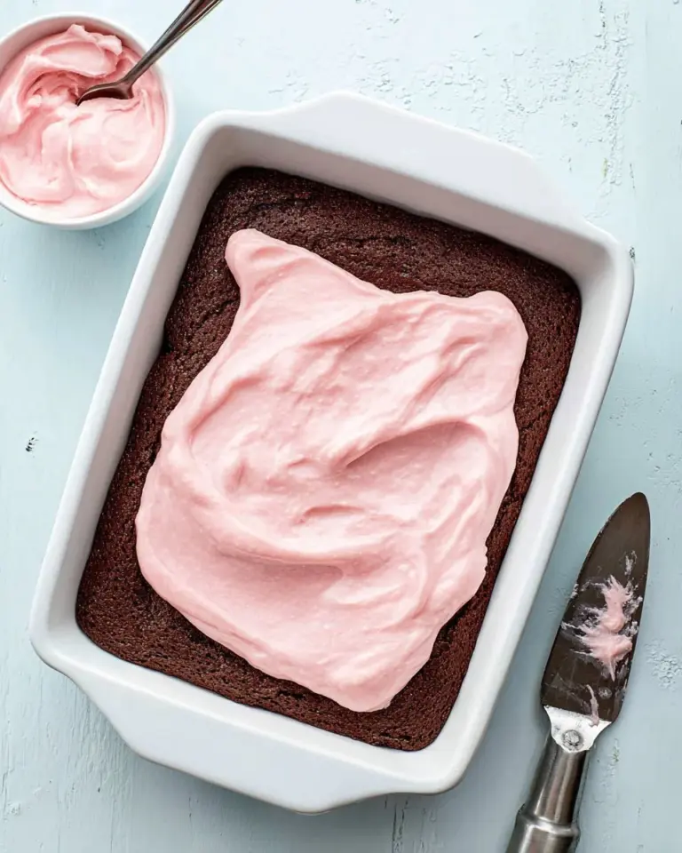 Delicious strawberry mousse brownies on a plate with fresh strawberries