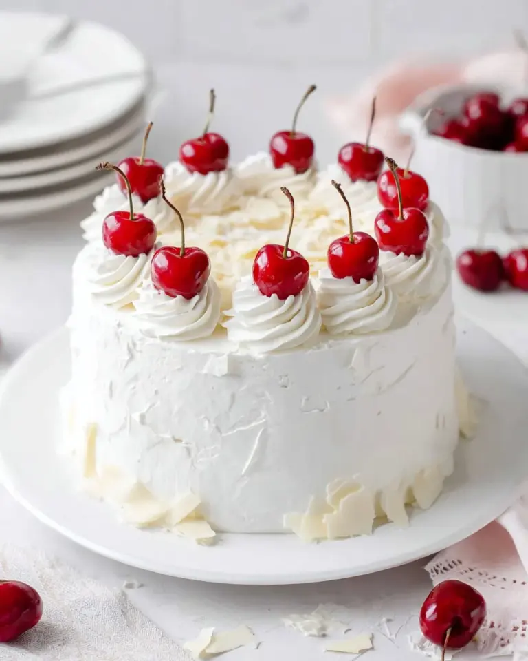 Delicious White Forest Cake with cherries and whipped cream layers