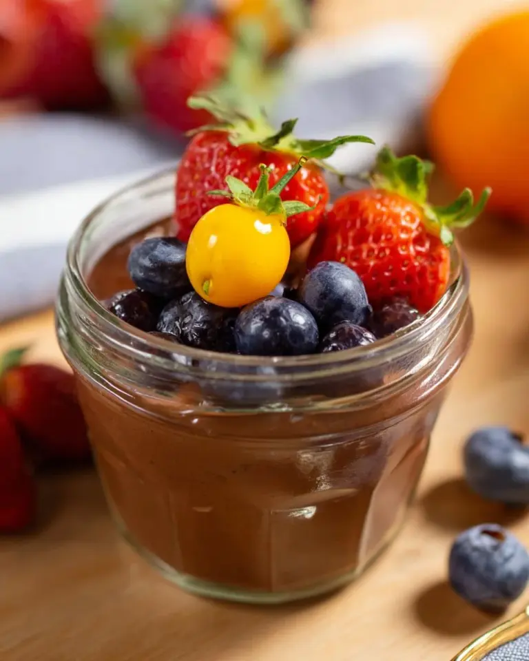 Decadent tofu chocolate mousse served in a glass with chocolate shavings on top.