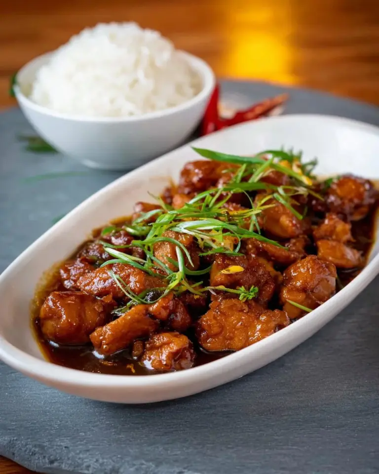 Delicious Vietnamese Caramel Chicken served with rice and herbs.