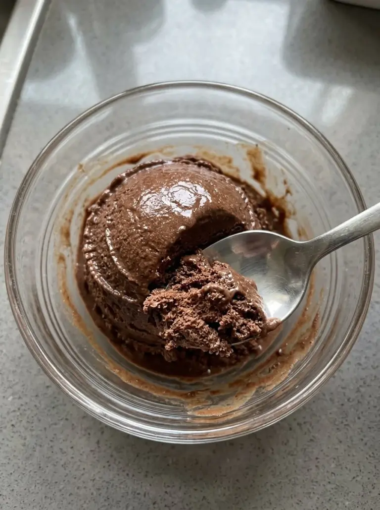Ninja Creami chocolate avocado ice cream in a bowl, topped with cocoa nibs