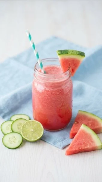 Cucumber watermelon smoothie in a glass with mint leaves